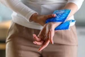 woman applying cold compress to a her painful